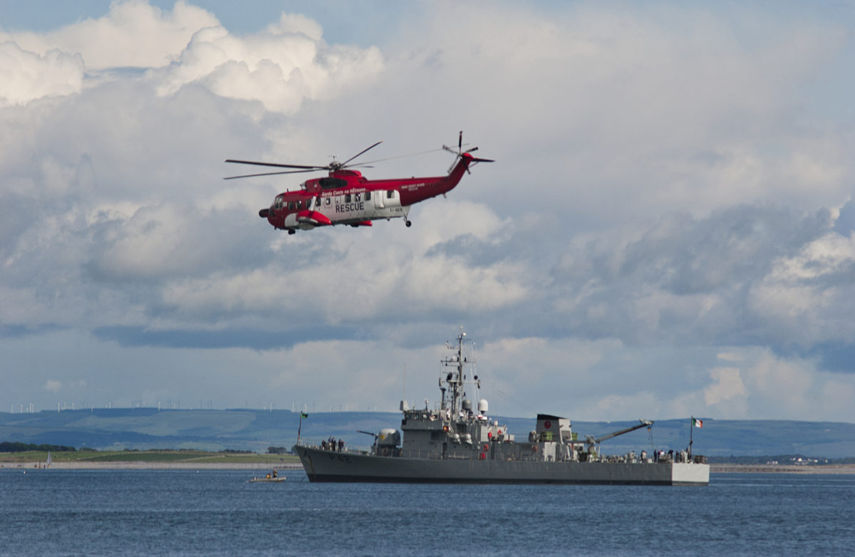 gabe9000c-dreamstime-com-irish-coast-guard-and-navy-photo_irish-coast-guard-sikorsky-s-61-search-and-rescue-helicopters-flying-by-irish-naval-ship